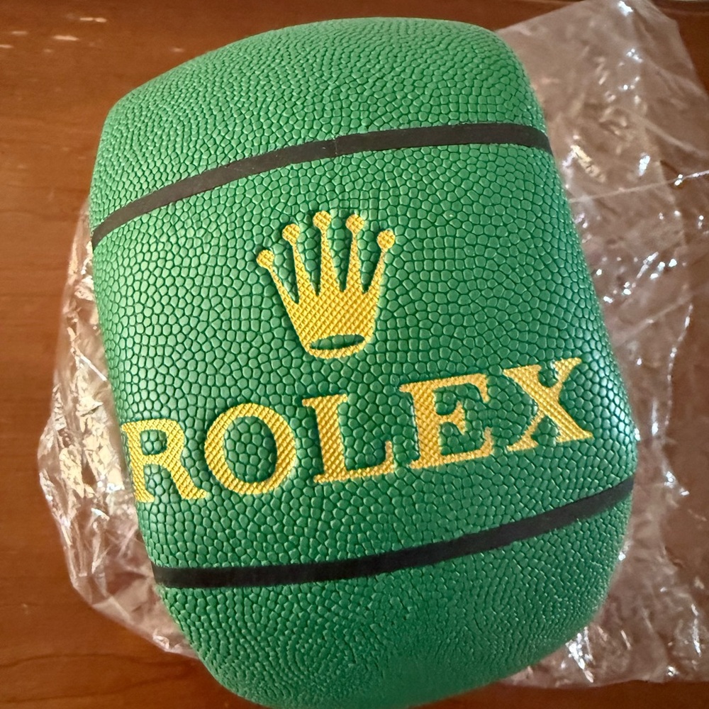 Green “Rolex” branding basketball